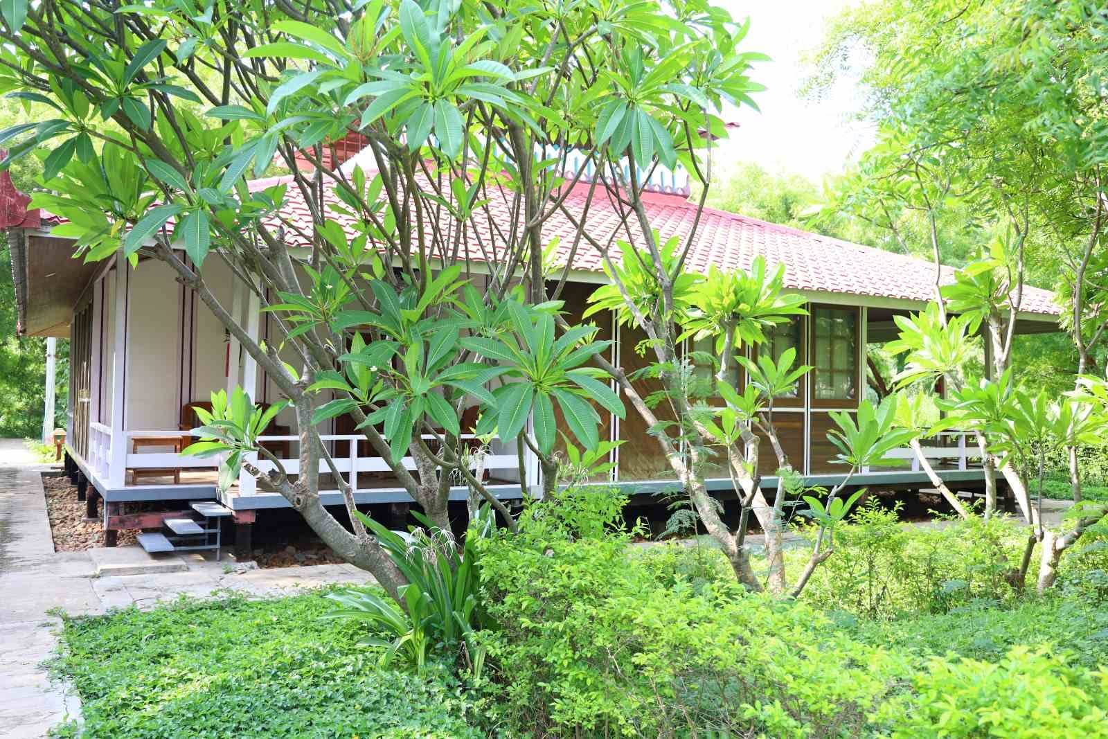 Garden villa with a red-tiled roof among frangipani trees at the Meiktila Hotel