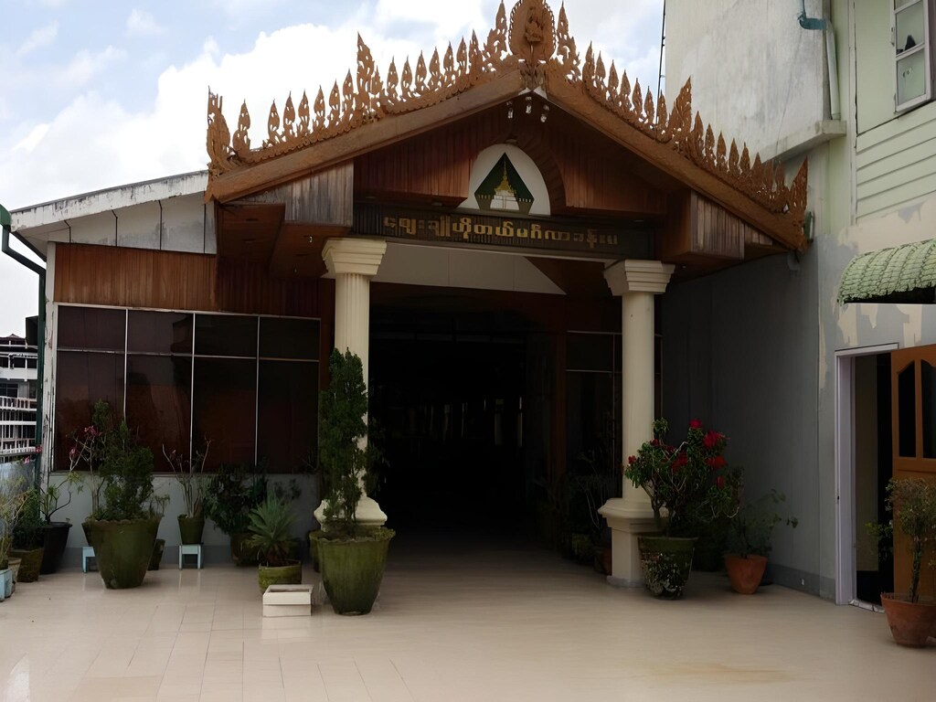 Ornate teak-gabled entrance of the Zegyo Lifestyle Hotel in Mandalay